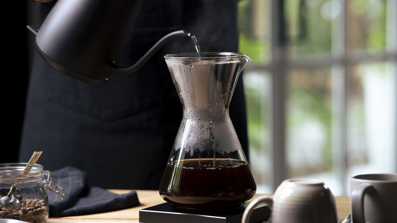 Kettle pouring water into coffee